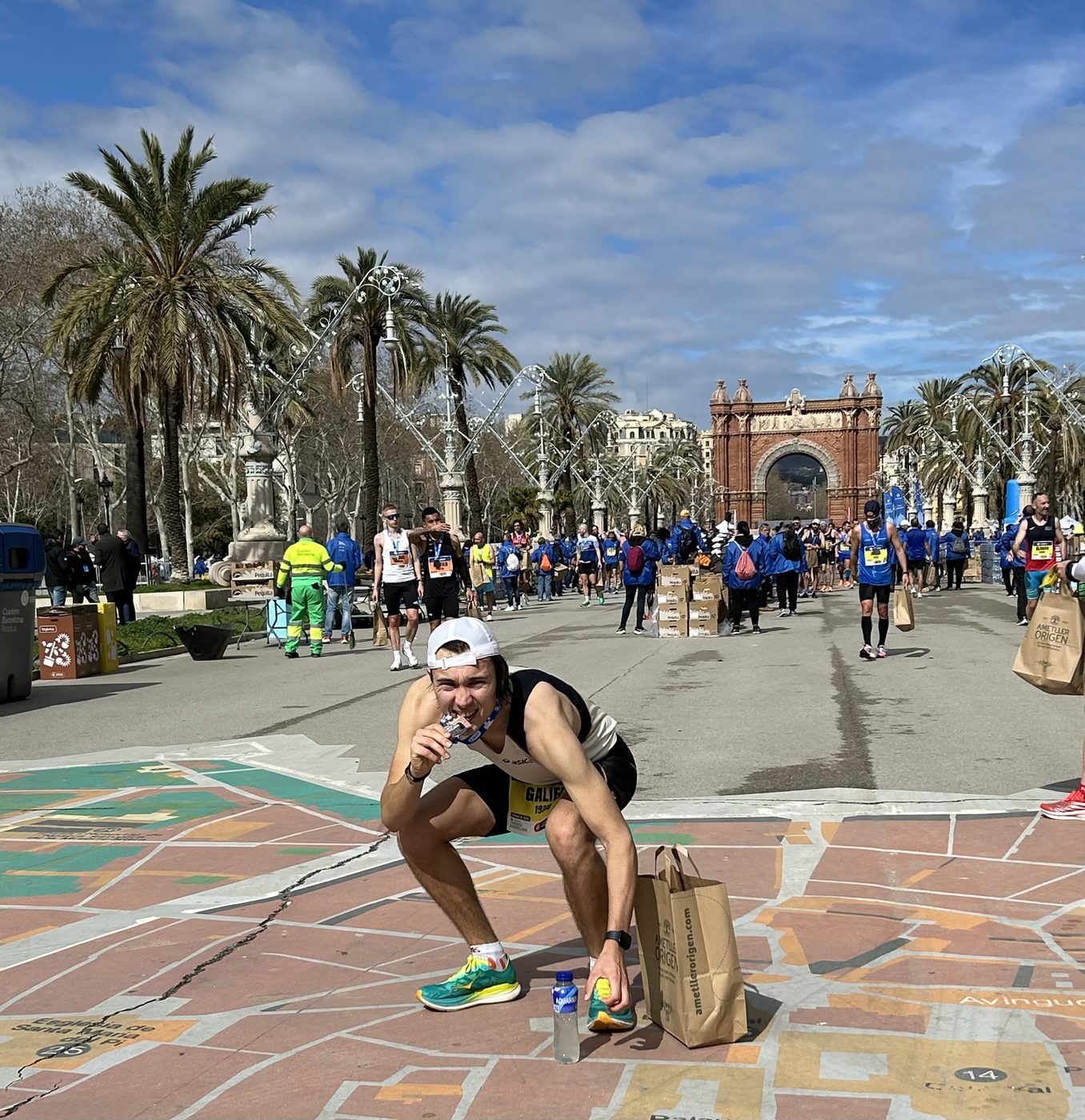Biting the medal after the Barcelona marathon finish