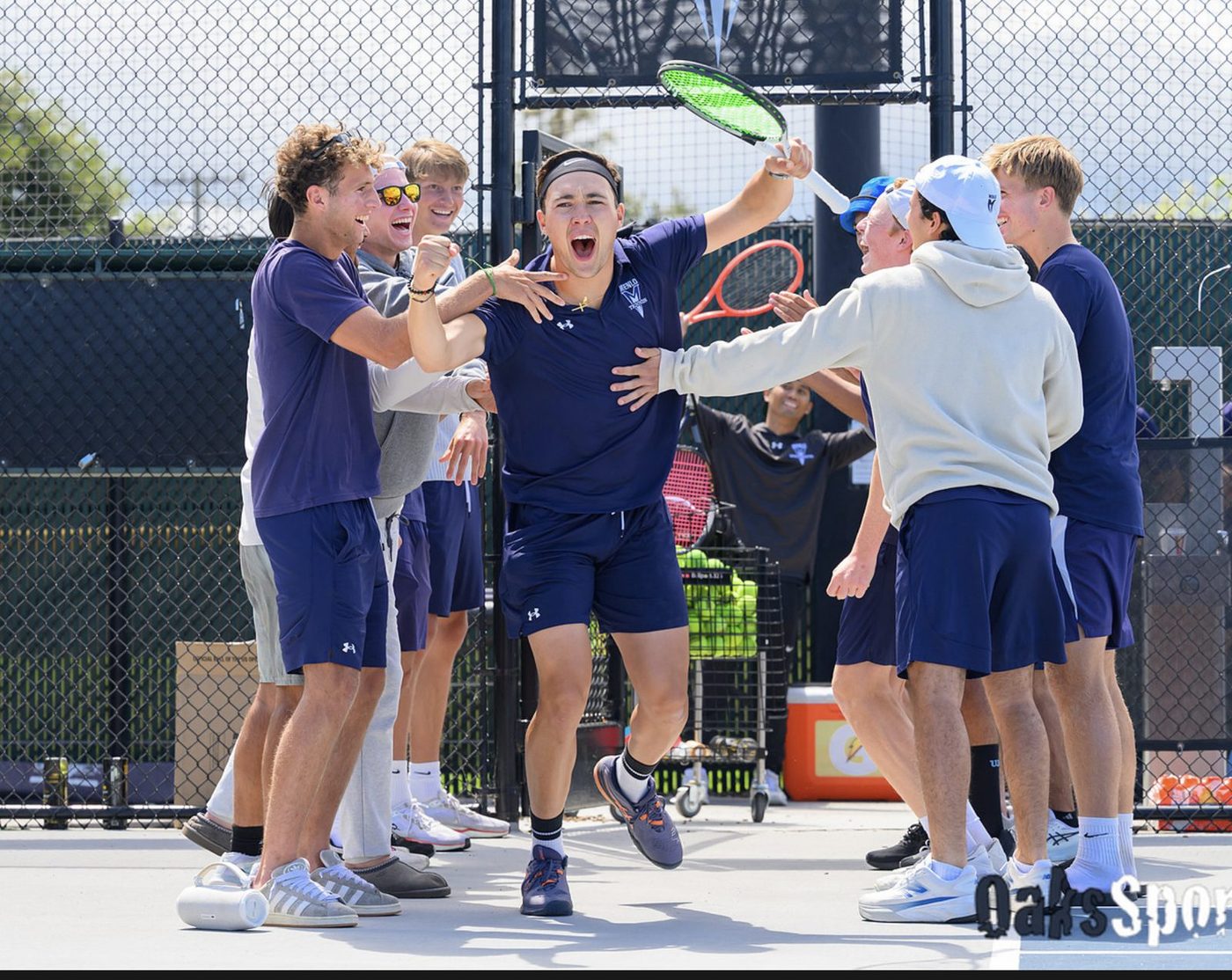 Galien Del Vecchio celebrating a match win with the Menlo College tennis team